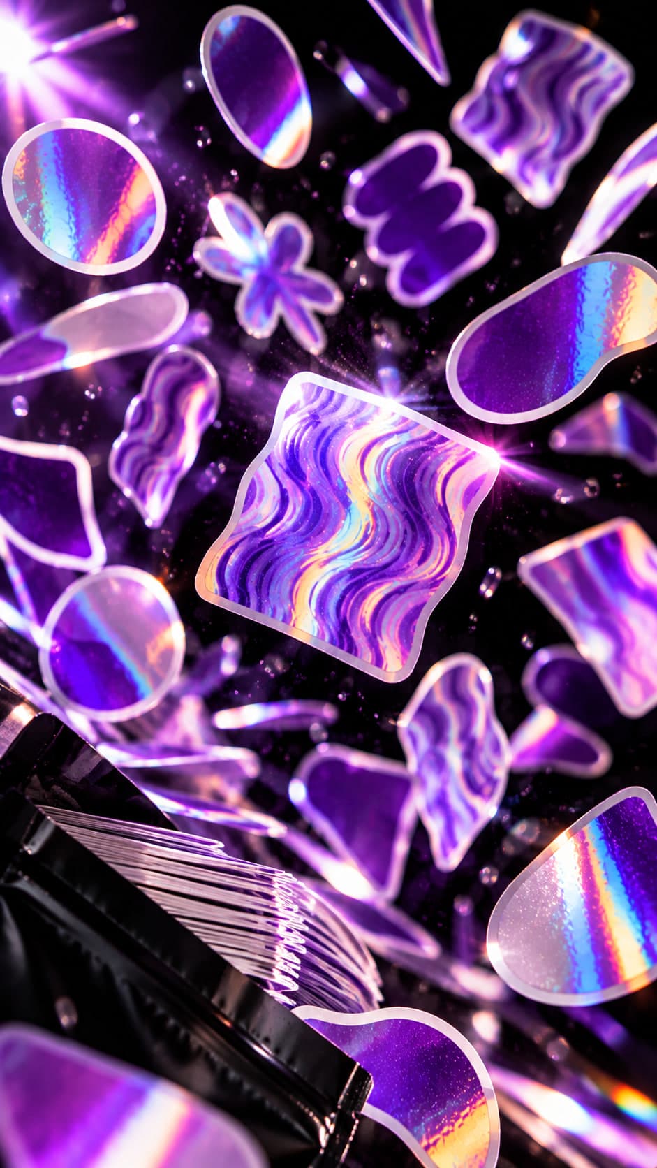 Dozens of holographic die-cut stickers in waves, circles, and blobs tumbling through violet light